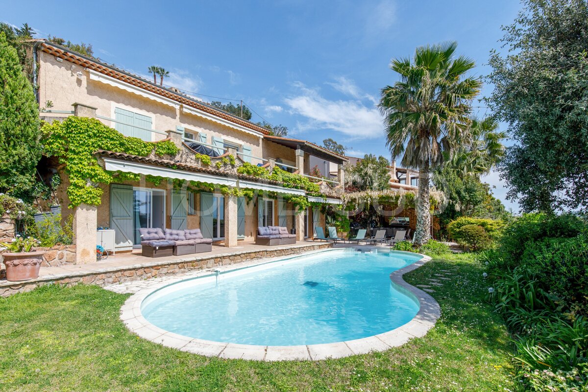 A large house with a large swimming pool in front of it
