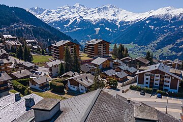 An aerial view of a ski resort with mountains in the background