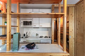 A small kitchen with a microwave and a sink