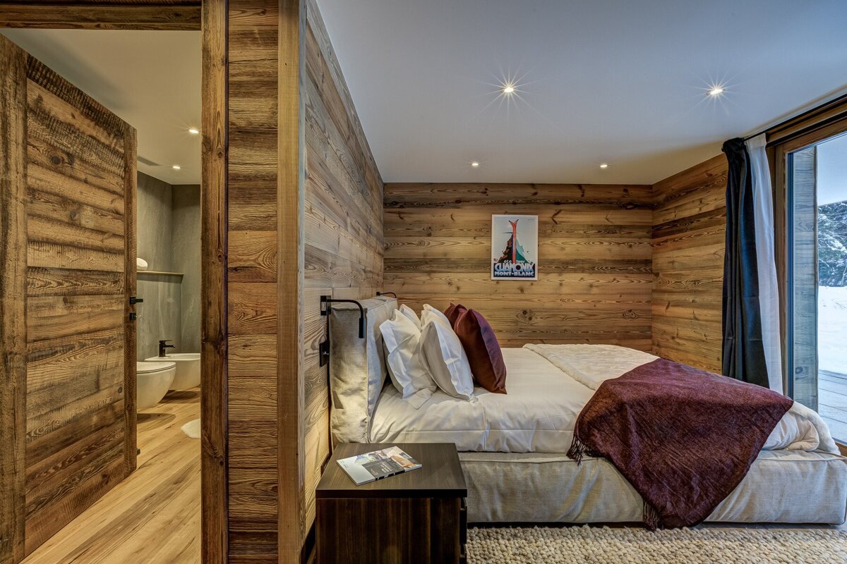 A bedroom with a bed and a picture on the wall that says ' switzerland '