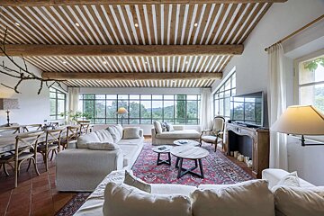 A living room with a striped ceiling and a fireplace