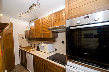 A kitchen with a bosch oven and a microwave