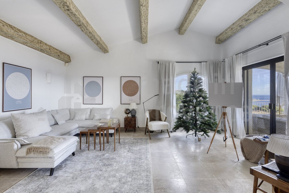 A living room with a christmas tree in the middle