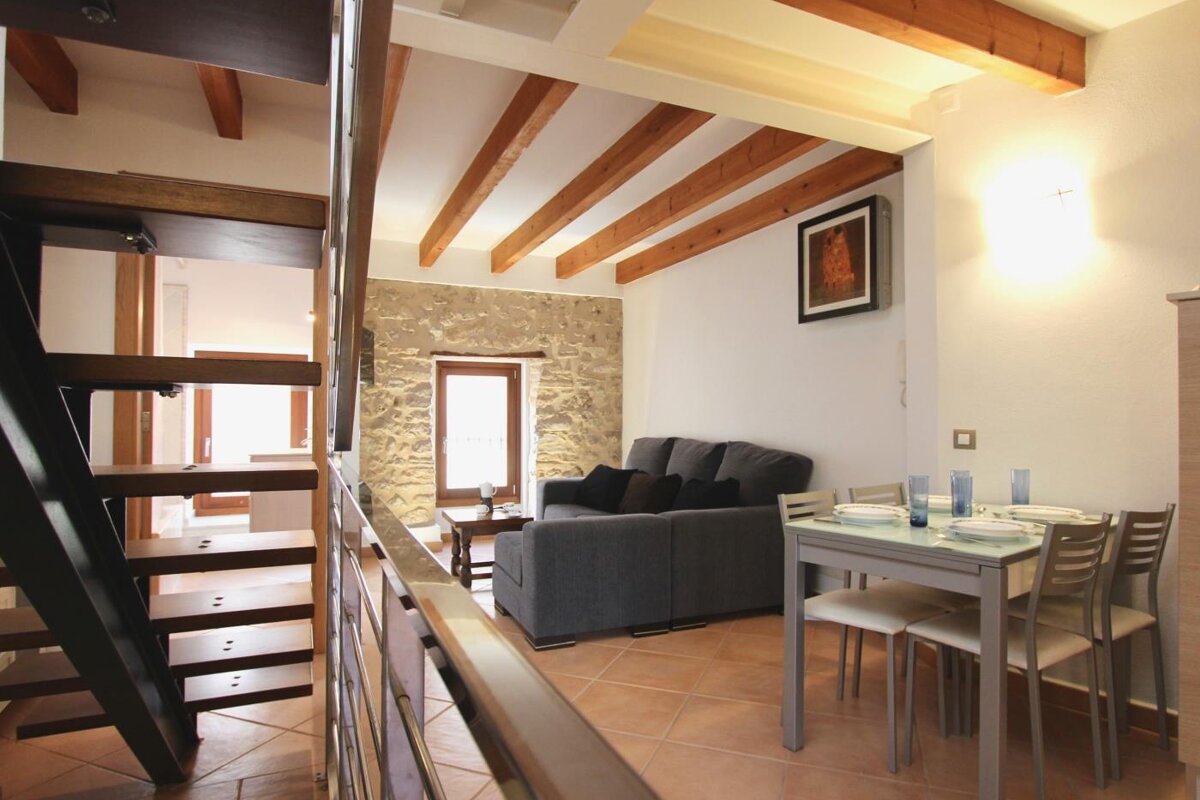 A living room with a couch and a table and chairs