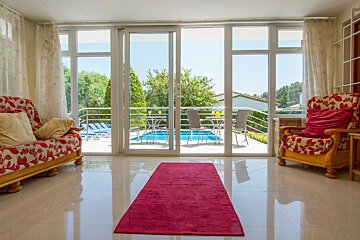 A living room with sliding glass doors leading to a swimming pool