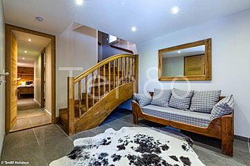 A wooden staircase leading up to the second floor of a house