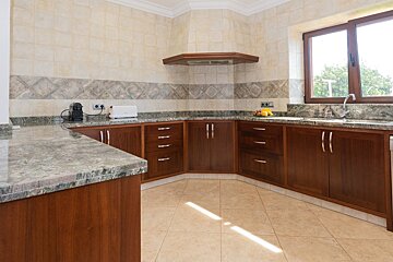 A kitchen with wooden cabinets and granite counter tops