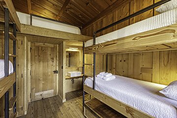 A room with bunk beds and a sink in it