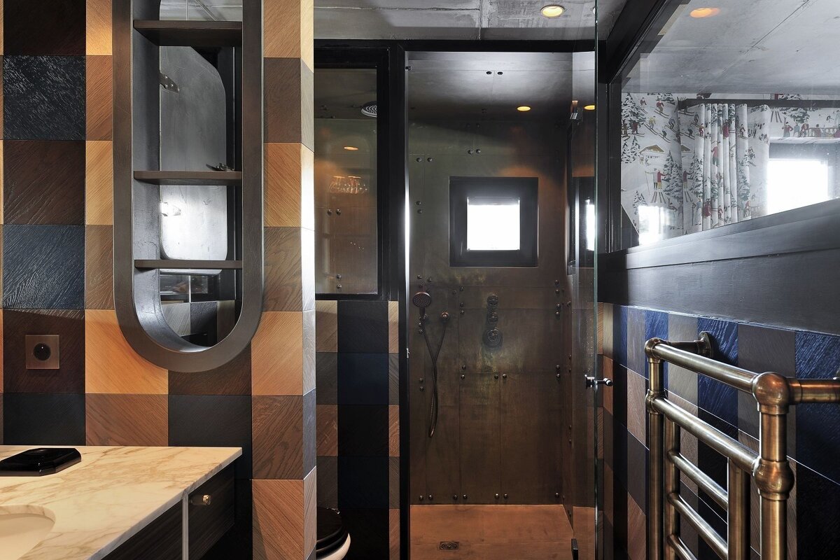 A bathroom with a walk in shower and a towel rack