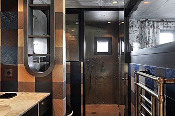 A bathroom with a walk in shower and a towel rack
