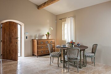 A room with a table and chairs and a dresser