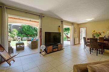 A living room with a flat screen tv on a stand