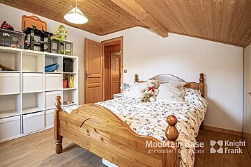 A bedroom with a bed and a shelf that says knight frank
