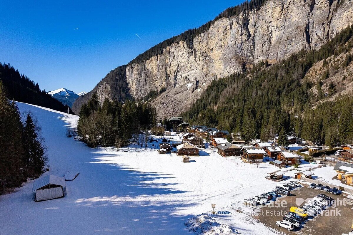 An aerial view of a snowy mountain village taken by chase real estate