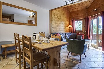 A living room with a wooden table and chairs