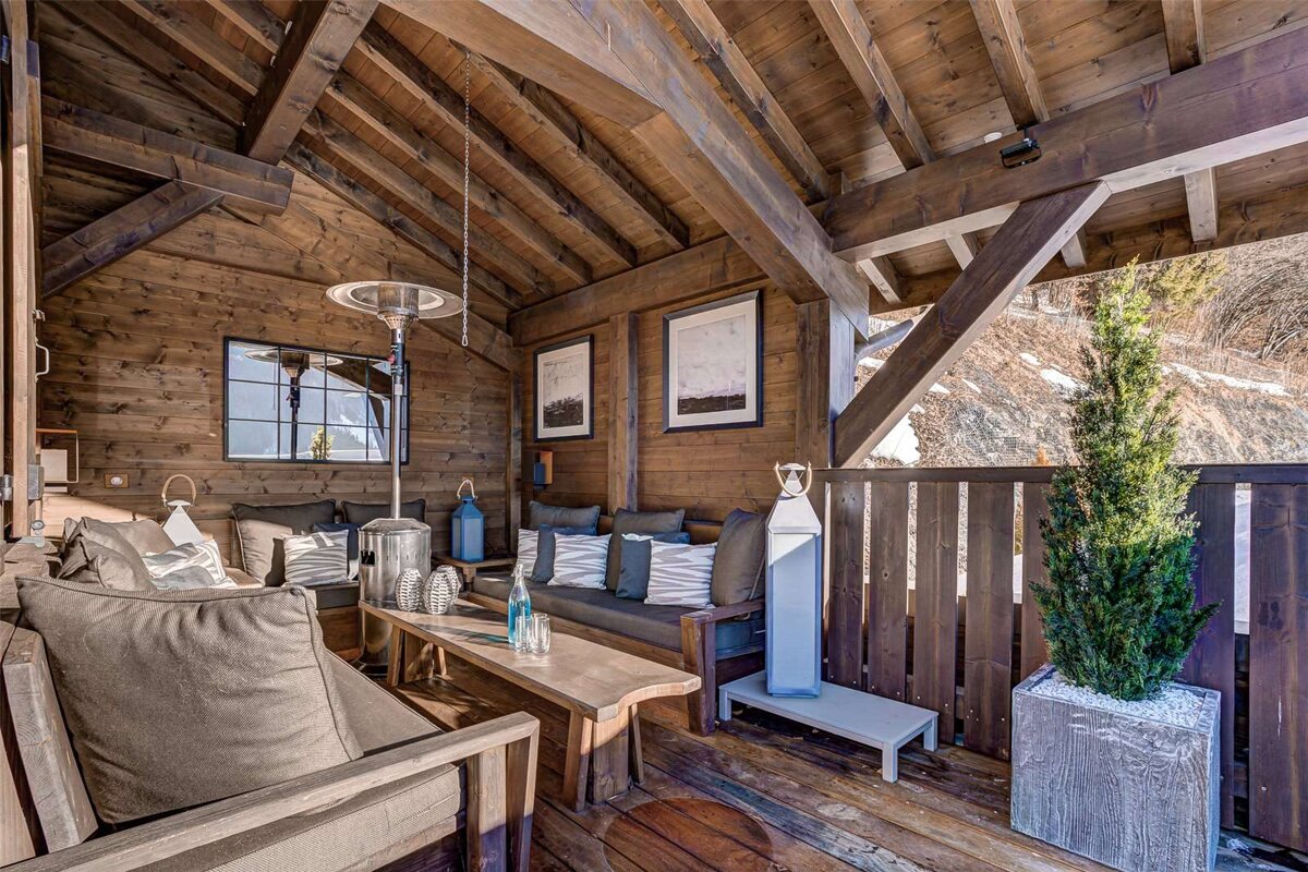 A wooden room with a couch and a table