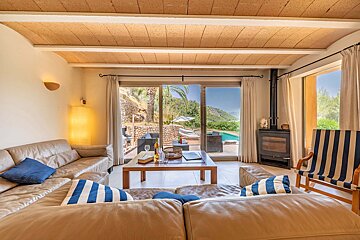 A living room with a sliding glass door leading to a pool
