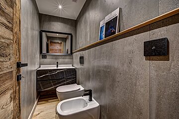 A bathroom with a toilet and a bidet