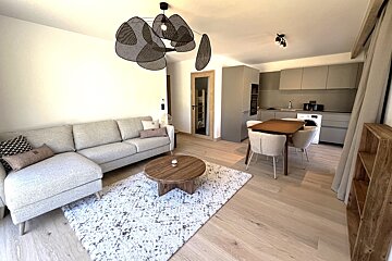 A living room with a couch a table and chairs