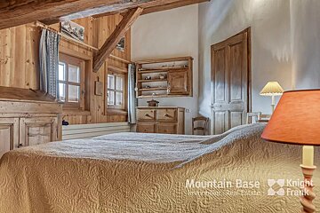 A bedroom with a bed and a lamp with knight frank written on the bottom