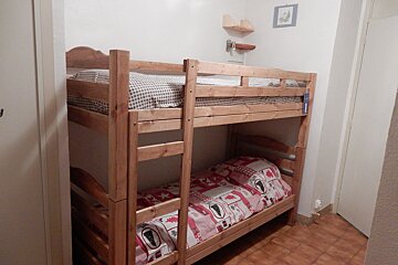 A bunk bed with a bear print on the sheets