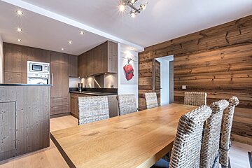 A kitchen with wooden cabinets and black counter tops