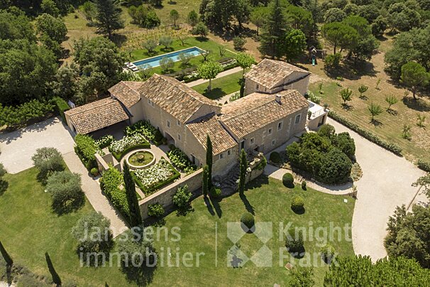 An aerial view of a large house for sale by janssens immobilier