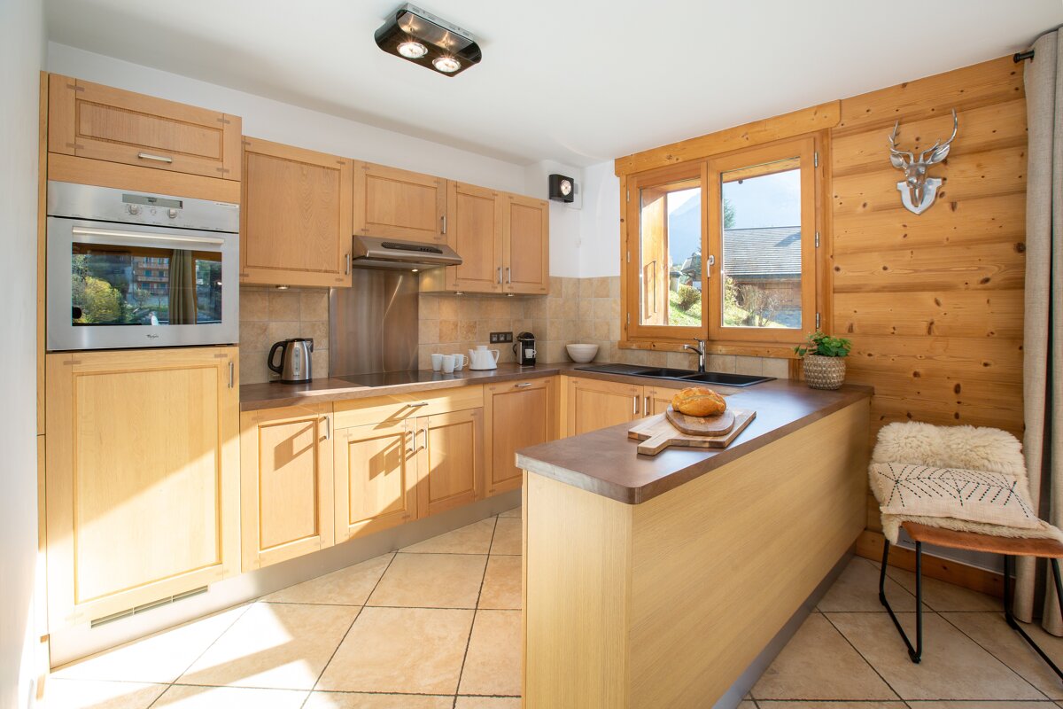 A kitchen with wooden cabinets and stainless steel appliances