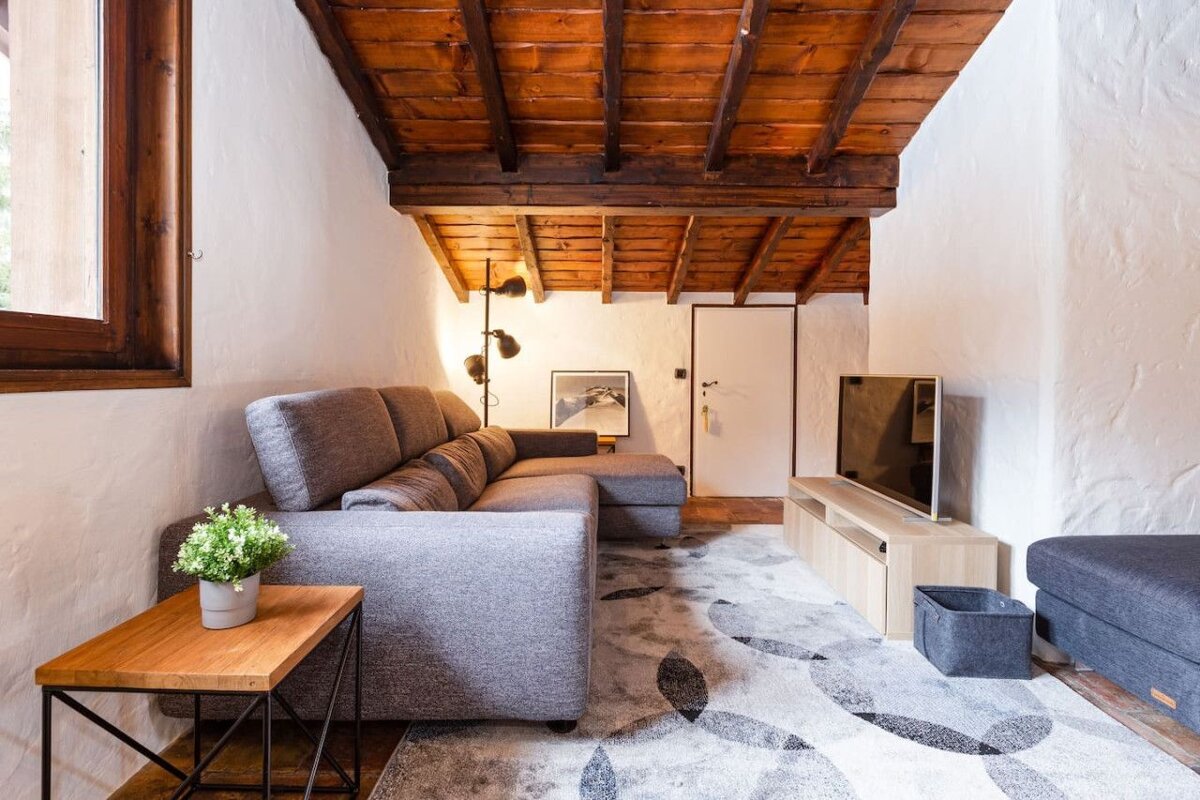 A living room with a couch and a flat screen tv