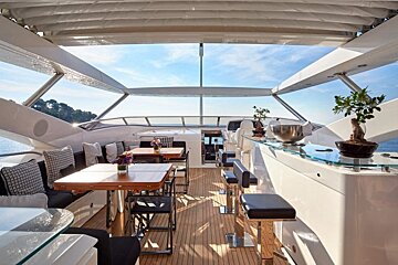 The inside of a boat with tables and chairs