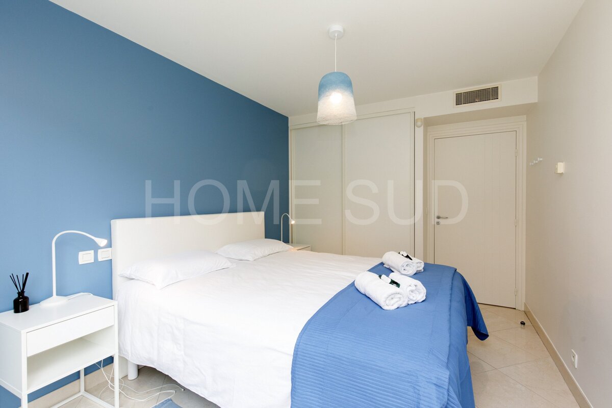 A bedroom with blue walls and the word home sud on the wall