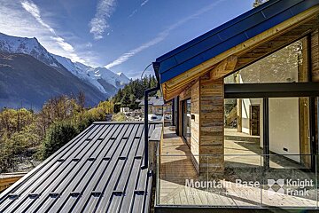 A mountain base knight frank building with a view of the mountains