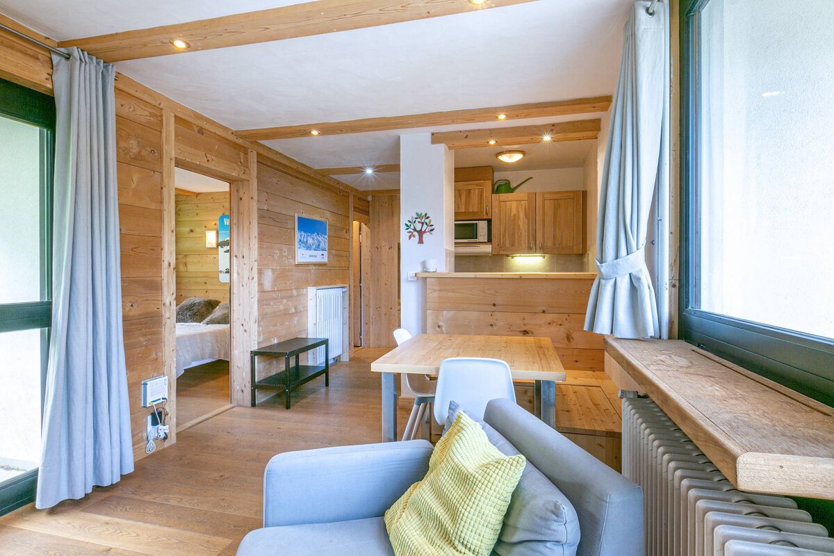 A living room with a couch a table and chairs