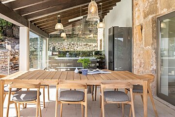 A table with chairs and a potted plant on it