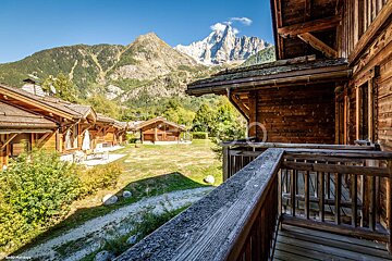 A balcony with a view of a mountain range