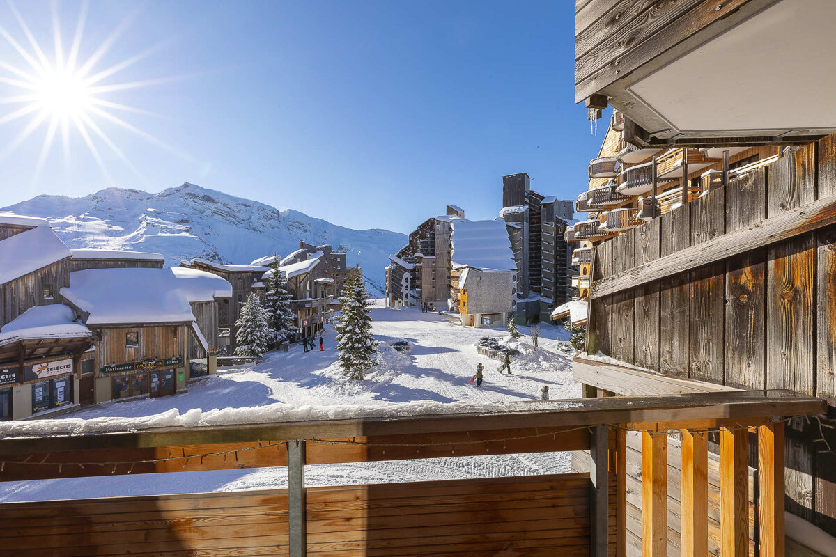 A view of a ski resort from a balcony with a sign that says ' altitude ' on it