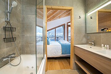 A bathroom with a bathtub a sink and a shower