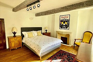 A bedroom with a poster on the wall that says bombery