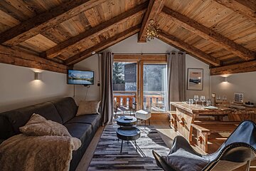 A living room with a wooden table and a couch