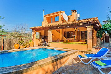 A house with a swimming pool in front of it