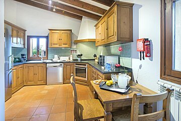 A kitchen with a fire extinguisher on the wall