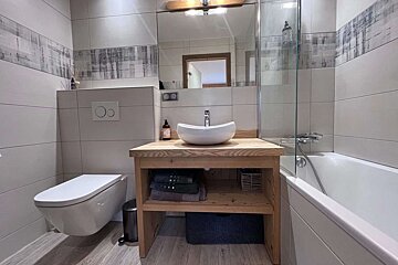 A bathroom with a toilet a sink and a bathtub