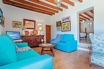 A living room with a blue couch and a table