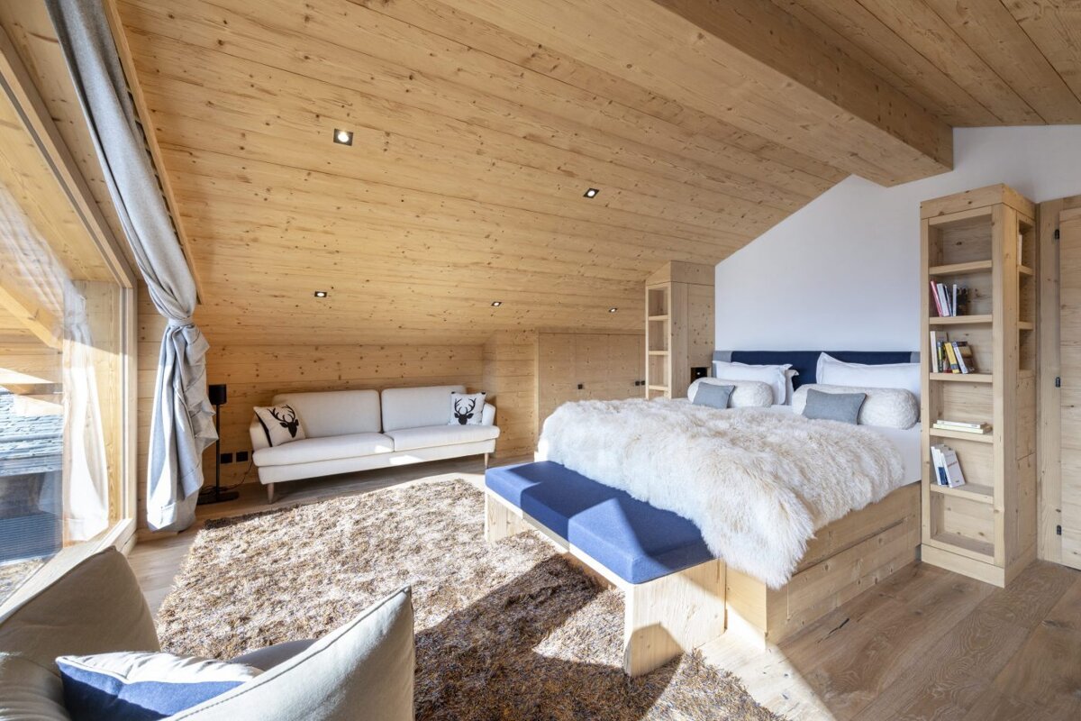A bedroom with a large bed and a couch