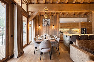 A dining room table with a picture of a wolf on the wall