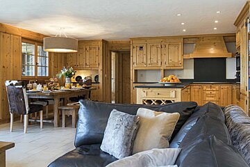 A living room with a couch and a dining table