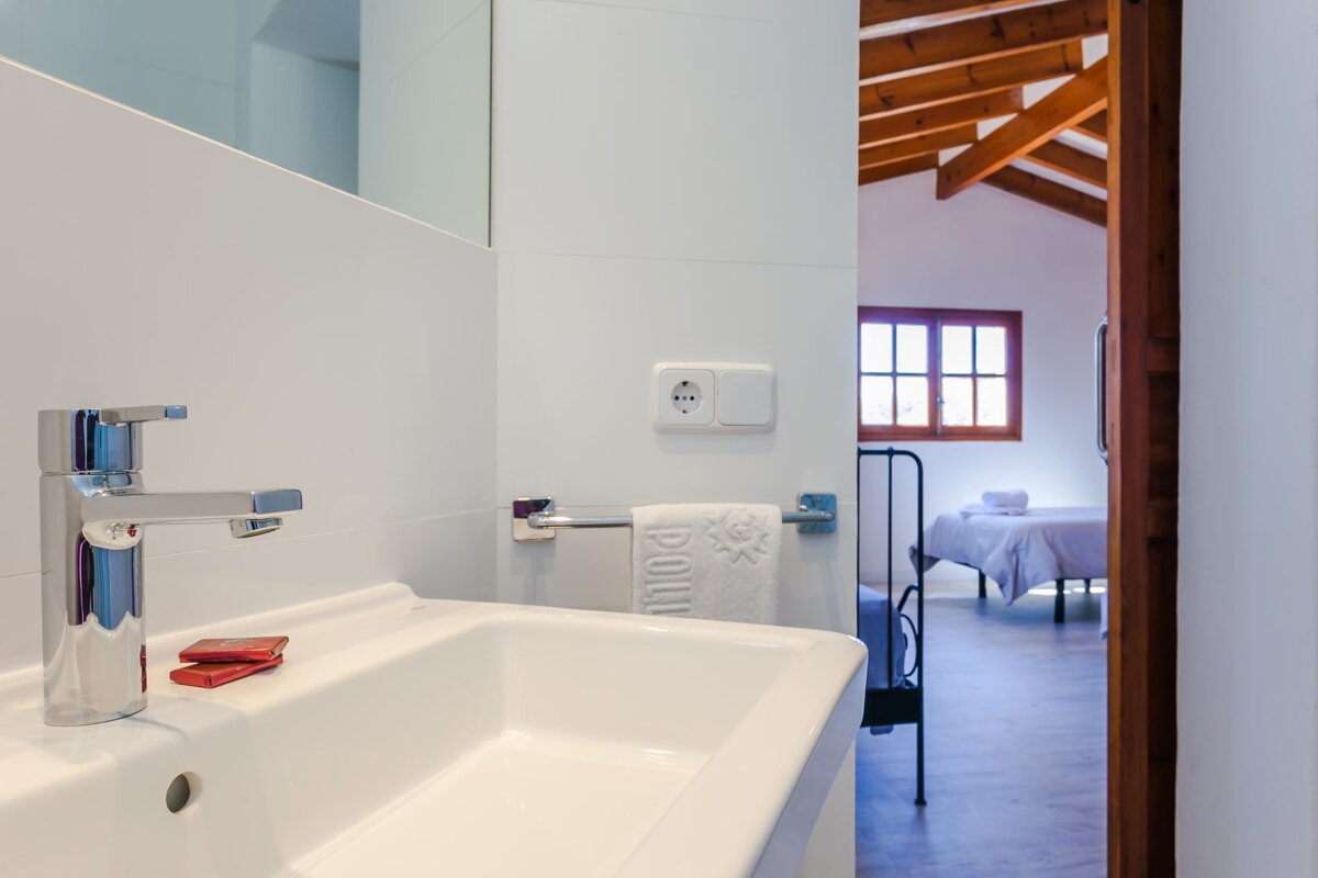 A bathroom sink with a towel that says polly on it