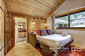 A bedroom with a bed and a knight frank logo