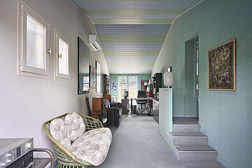 A long hallway with a couch in the middle