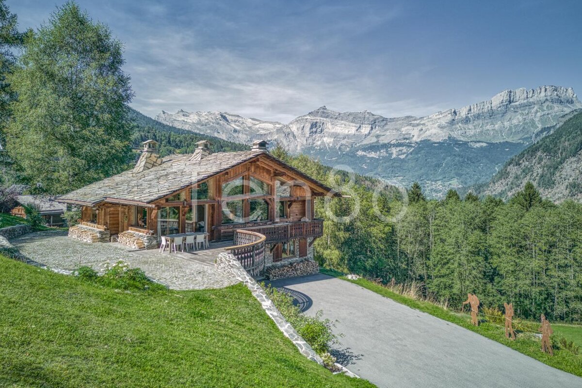A large house with mountains in the background is for sale